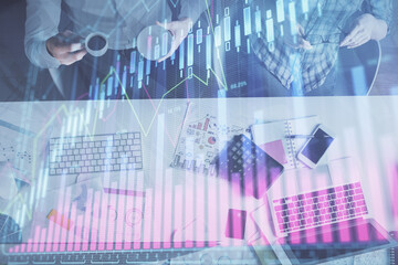 Double exposure of man and woman working together and financial chart hologram drawing. market analysis concept. Computer background. Top View.