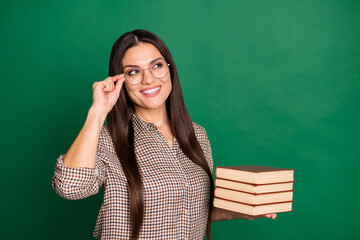 Photo of charming mature lady hold pile book look empty space wear specs plaid shirt isolated green color background