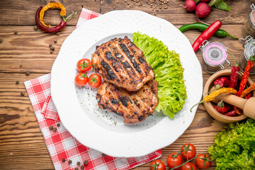 roasted chicken with herbs served on a plate  vegetables and grapes