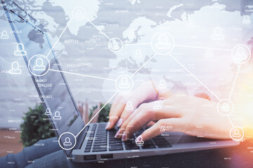 Double exposure of woman hands typing on computer and social network theme hologram drawing. People media concept.