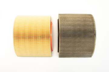 Car air filters, clean and dirty. Isolated on a white background. The need to replace filters during maintenance. Selective focus.