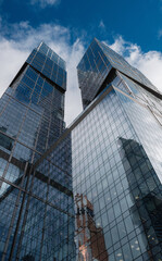 Modern corporate buildings against blue cloud sky.