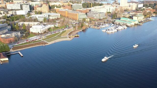 Cinematic sunset aerial drone footage of Fritz Hedges Waterway Park by the Ship Canal Bridge with the University of Washington and Portage Bay near downtown Seattle in King County, Washington