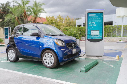 Pasadena, CA, USA - March 10, 2021: image of a Smart EQ fortwo vehicle shown at a free charging station. Smart is a German automotive brand.