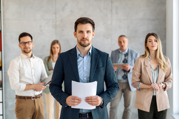 Group of business people and software developers working as a team in office