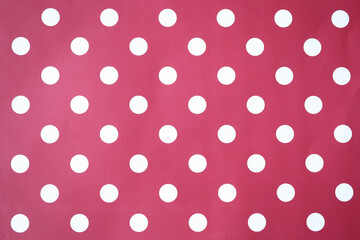 Red background with white circles. Polka dot closeup