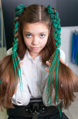 Teenager girl with colored pigtails