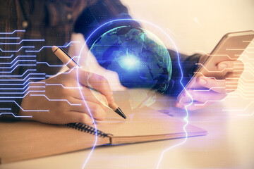 Double exposure of brain sketch hologram and woman holding and using a mobile device.