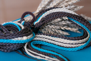 Fototapeta na wymiar Hair accessory elastic with braids brown blue color