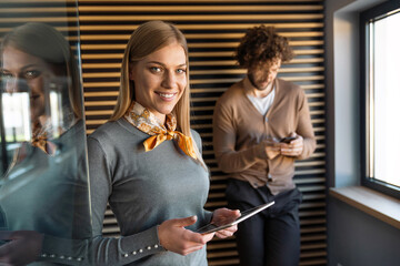 Portrait of professional business woman with digital tablet in corporate office