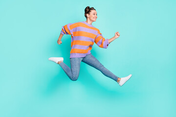Fototapeta na wymiar Full length body size view of attractive active cheerful girl jumping running isolated over bright teal turquoise color background