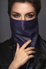 Portrait of stylish woman wearing leather neck gaiter instead of prevention mask.