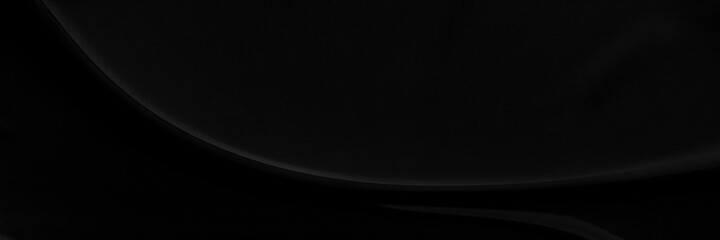 Black gray satin dark fabric texture luxurious shiny that is abstract silk cloth panorama background with patterns soft waves blur beautiful.