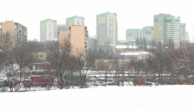 It is snowing. Snow-covered multi-storey tipical building. Winter, empty city. Kyiv, Ukraine
