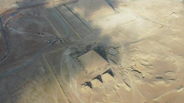 Aerial Drone shot revealing all 3 pyramids and into the city of Cairo, Egypt