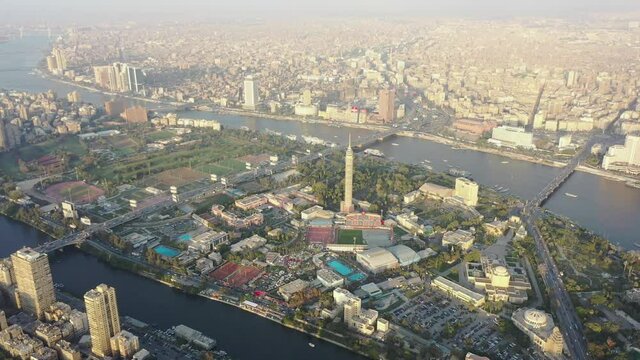 Aerial drone shot of downtown Cairo, Egypt panning to the right revealing Nile River and Tahrir sq