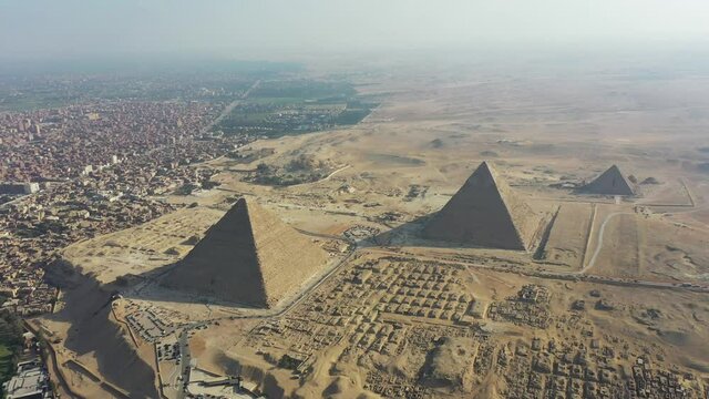 Aerial Panning to the Right shot of 3 pyramids and desert in Giza, Egypt