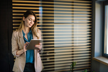 Successful business woman working on tablet in office