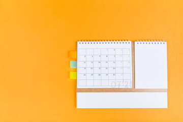 closing month calendar for 2021 on orange background, planning a business meeting or travel...