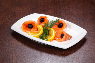Sliced salmon snack with lemon