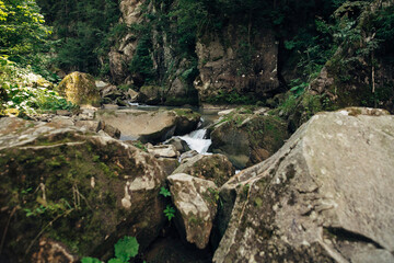 River with rocks in mountains. Travel and wanderlust. Waterfall on river with stone cascade.Peaceful