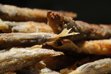 Pan fried fish on a plate. Small crispy fish. Selective focus