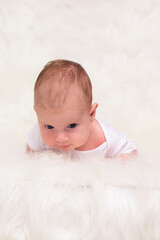 Newborn Baby Concepts. Portrait of Caucasian Newborn Boy Lying on Bed With Lifted Head. Macro Shoot.