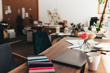 Interior designer workplace with laptop and fabric color palette