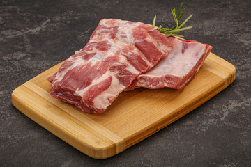 Raw pork ribs served rosemary