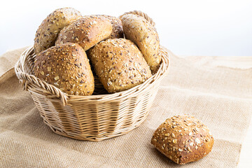 Freshly baked bread. Fresh loaf of rustic traditional bread with wheat grain ear or spike plant on linen texture background. Rye bakery with crusty loaves and crumbs. Healthy Food concept.