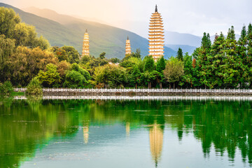Beautiful scenic view of Dali Three Pagodas of Chongsheng Temple with water reflection and dramatic...