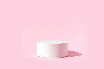 Empty white podium on pastel pink background. Minimal geometric podium. Scene with geometric...