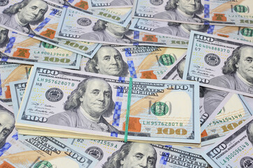 One hundred dollars pile on 100 dollars  background. Money concept  and finance. Business background