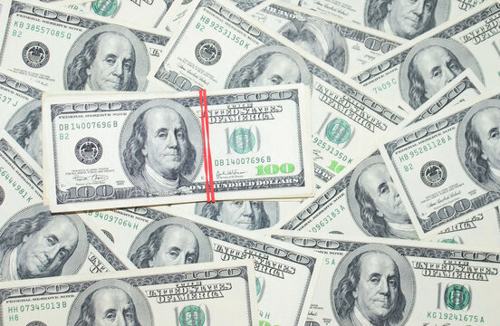 One hundred dollars pile on 100 dollars  background. Money concept  and finance. Business background