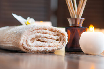 Obraz na płótnie Canvas Spa background. Towel, candles, flowers, aroma sticks, massaging stones and herbal balls. Massage, oriental therapy, wellbeing and meditation.