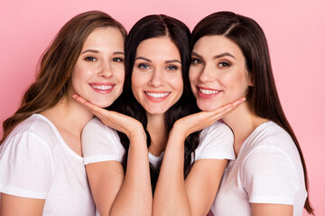 Photo of three young attractive girls happy positive smile sisters together isolated over pink color background