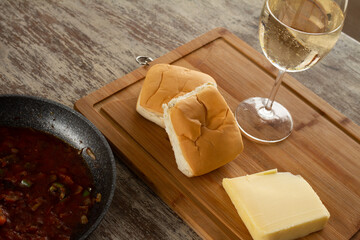 Round crystal glass with cold white wine. Rural rustic kitchen. Fermented grape juice.