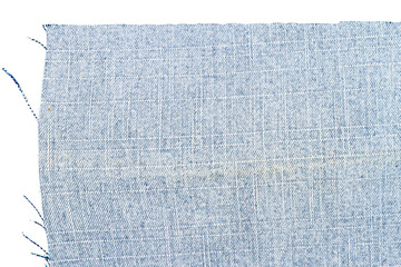 Piece of light blue jeans fabric