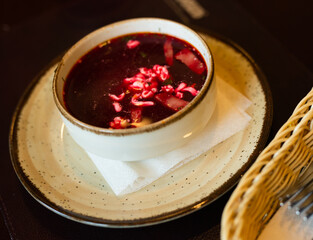 Appetizing hot borscht with sour cream in bowl