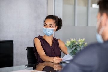 African business woman in office with face mask