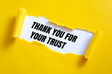 Thank you for your trust. text on white paper over torn paper background.