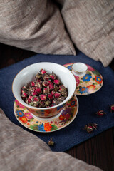 Beautiful cup with dried tea rose flowers