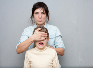 Mother   closing  her child's eyes. Problems of relations between parents and children