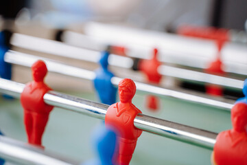 Kicker table for table football with blue and red players