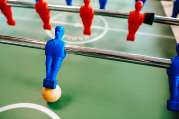 Kicker table for table football with blue and red players