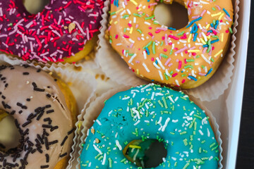 Donuts of different colors in a box