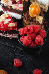 A piece of Lenten cake with raspberries on a dark background. Delicious and beautiful pastries in a pastry shop. Holiday Sweets