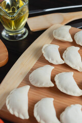 homemade natural farm dumplings and dumplings on the table with vegetables and herbs.