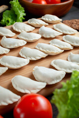 homemade natural farm dumplings and dumplings on the table with vegetables and herbs.