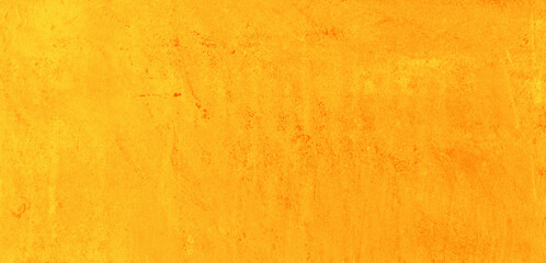 Yellow speckled hand-painted illustration texture design of old distressed vintage grunge concrete with orange stains. damaged textured abstract washed cement backdrop as web banner background.